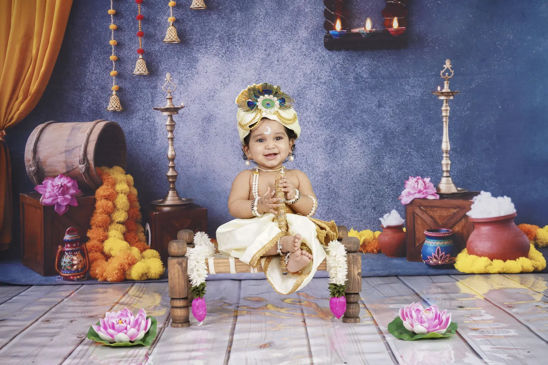 Baby dressed as Krishna in festive temple set